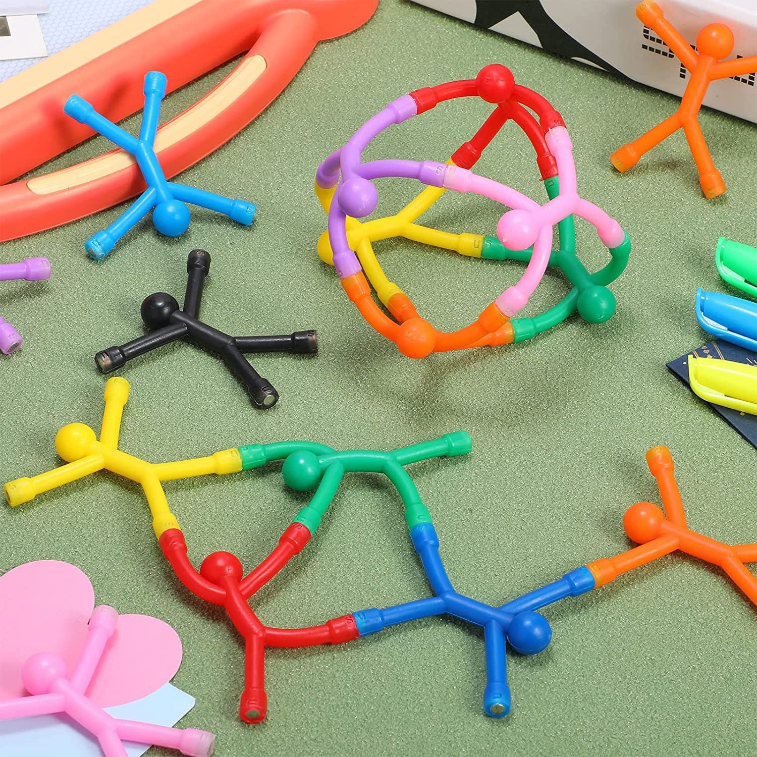 Colorful bendy magnetic men figures scattered on a play table