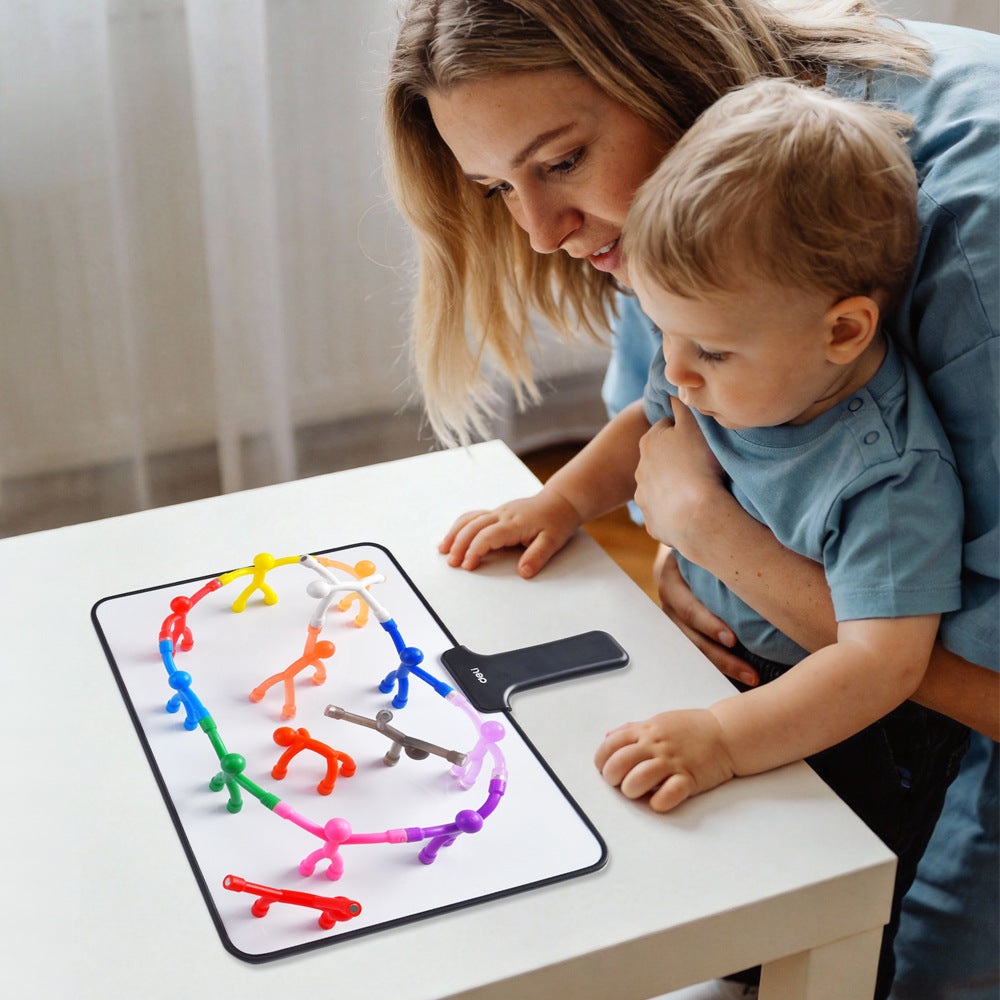 Mom and toddler playing with magnetic men on the magnetic board