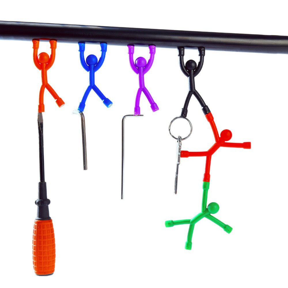 Magnetic men hanging from a metal bar by their magnetic hands