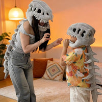 Parent and child wearing the 3D dinosaur skeleton cape and skull hood, face to face