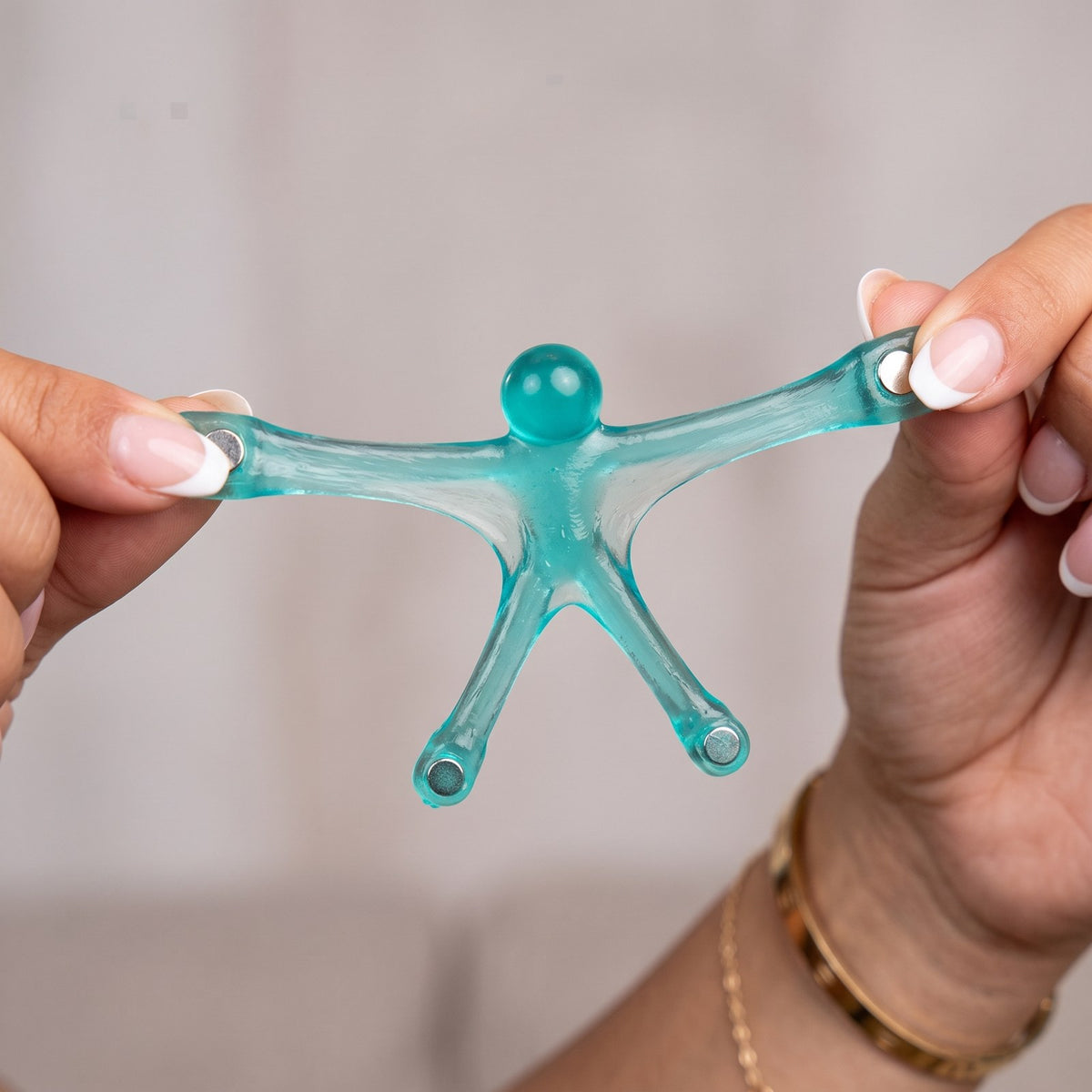 Stretching a translucent magnetic man between two hands